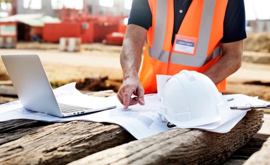 Construction Worker With Laptop Has IT Requirements